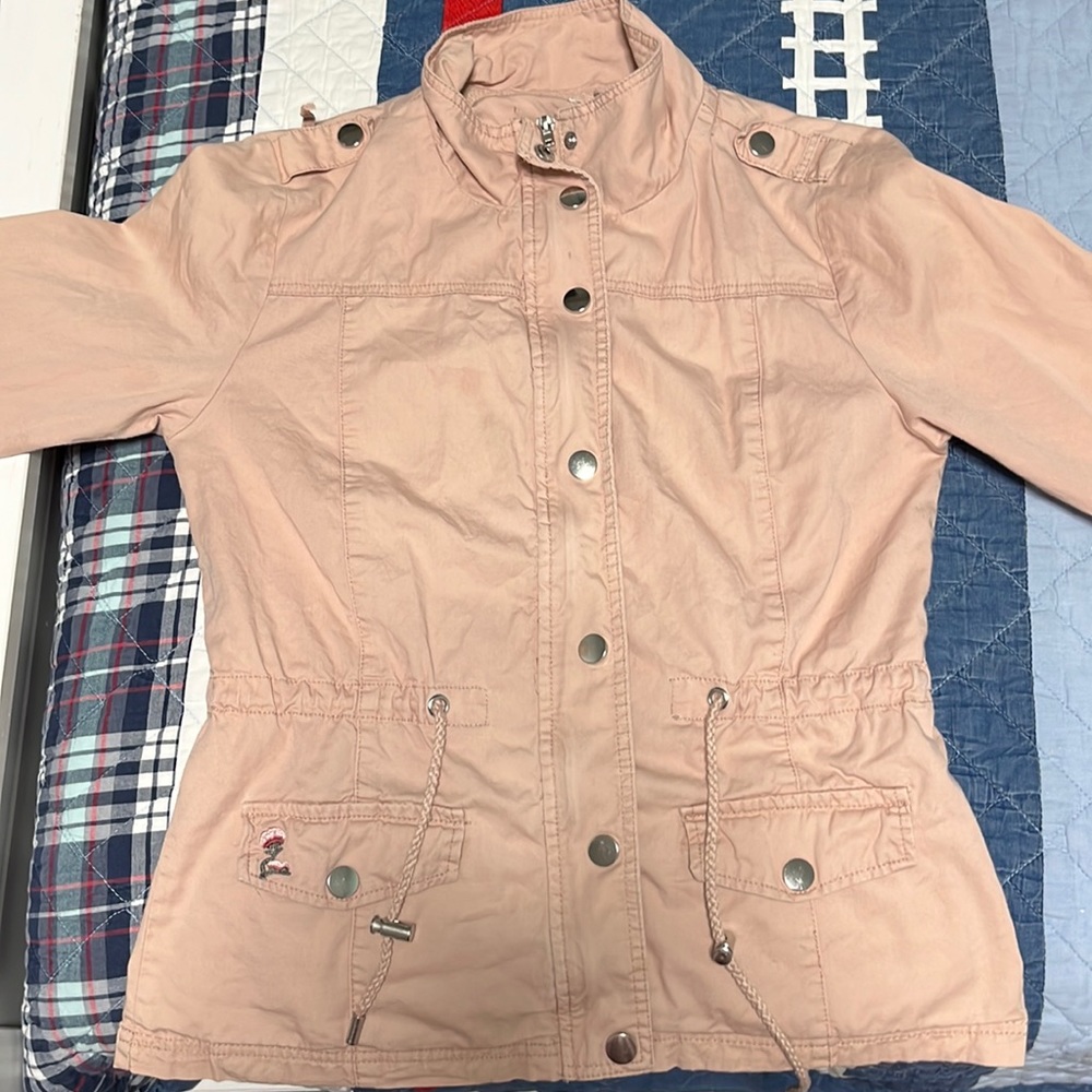 A light pink coat. Has a nice embroidery on the back.